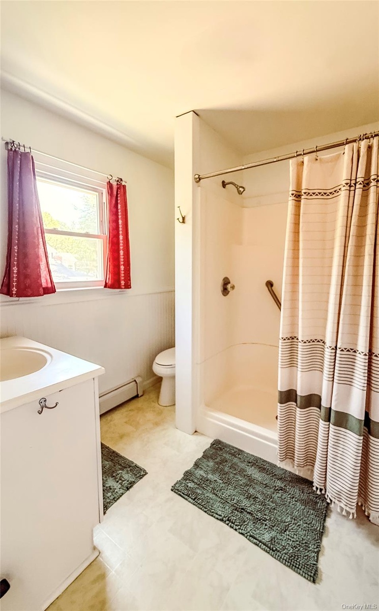Upper Apartment  Full Bathroom with window and blinds