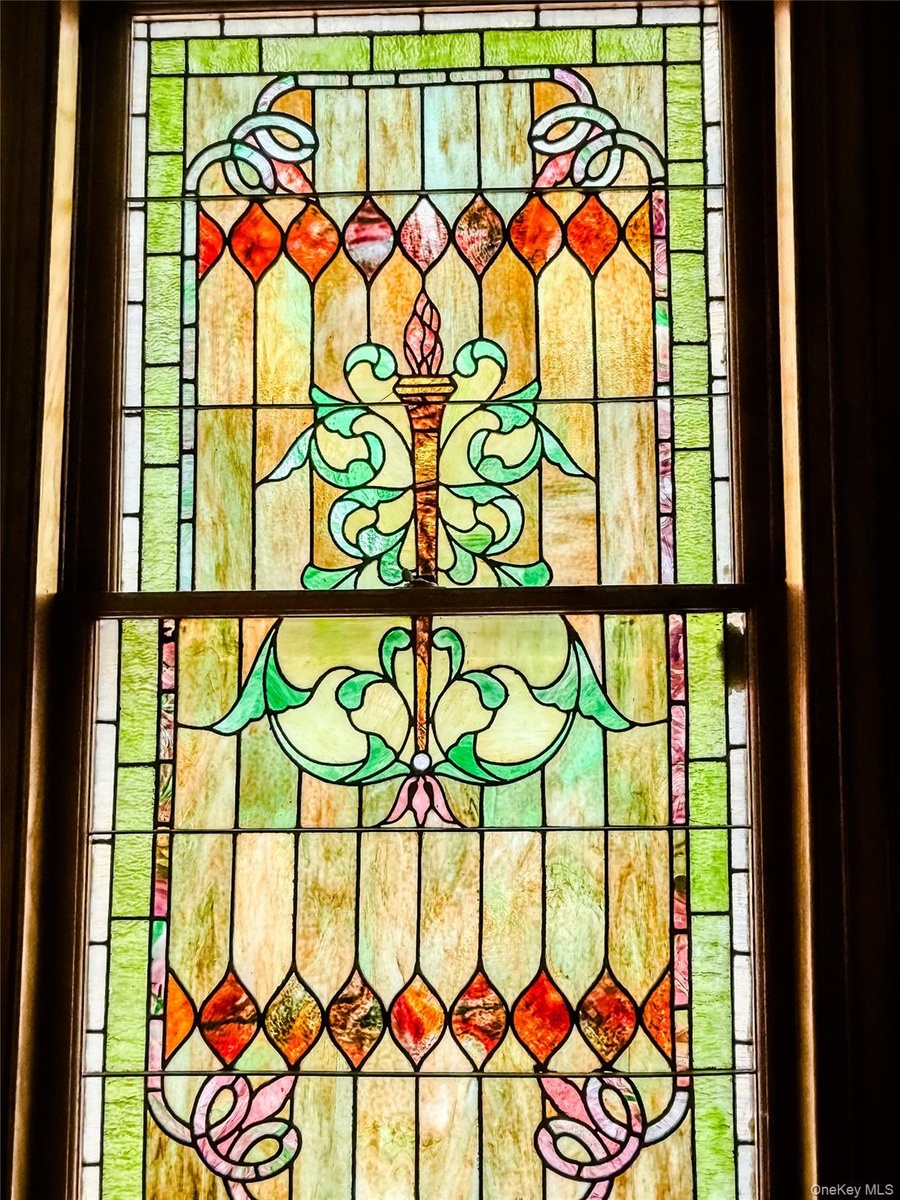 Stained glass window featuring an ornate, multi-color design