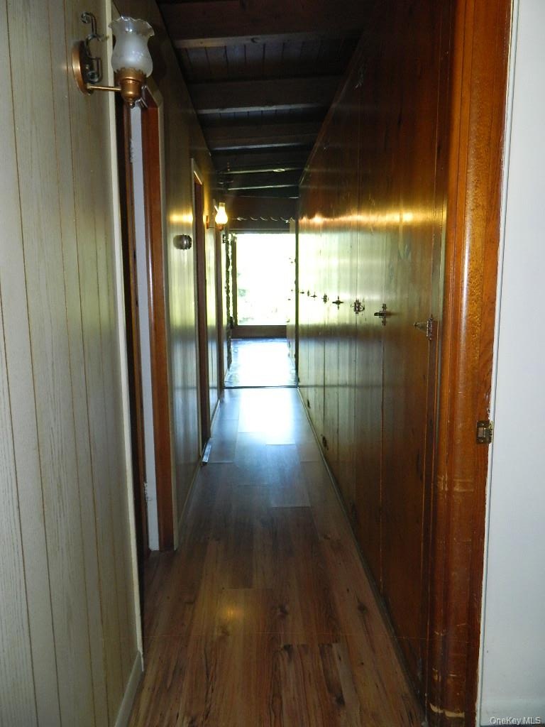 Floor to ceiling knotty pine cabinets all the way down the hallway, storage galore