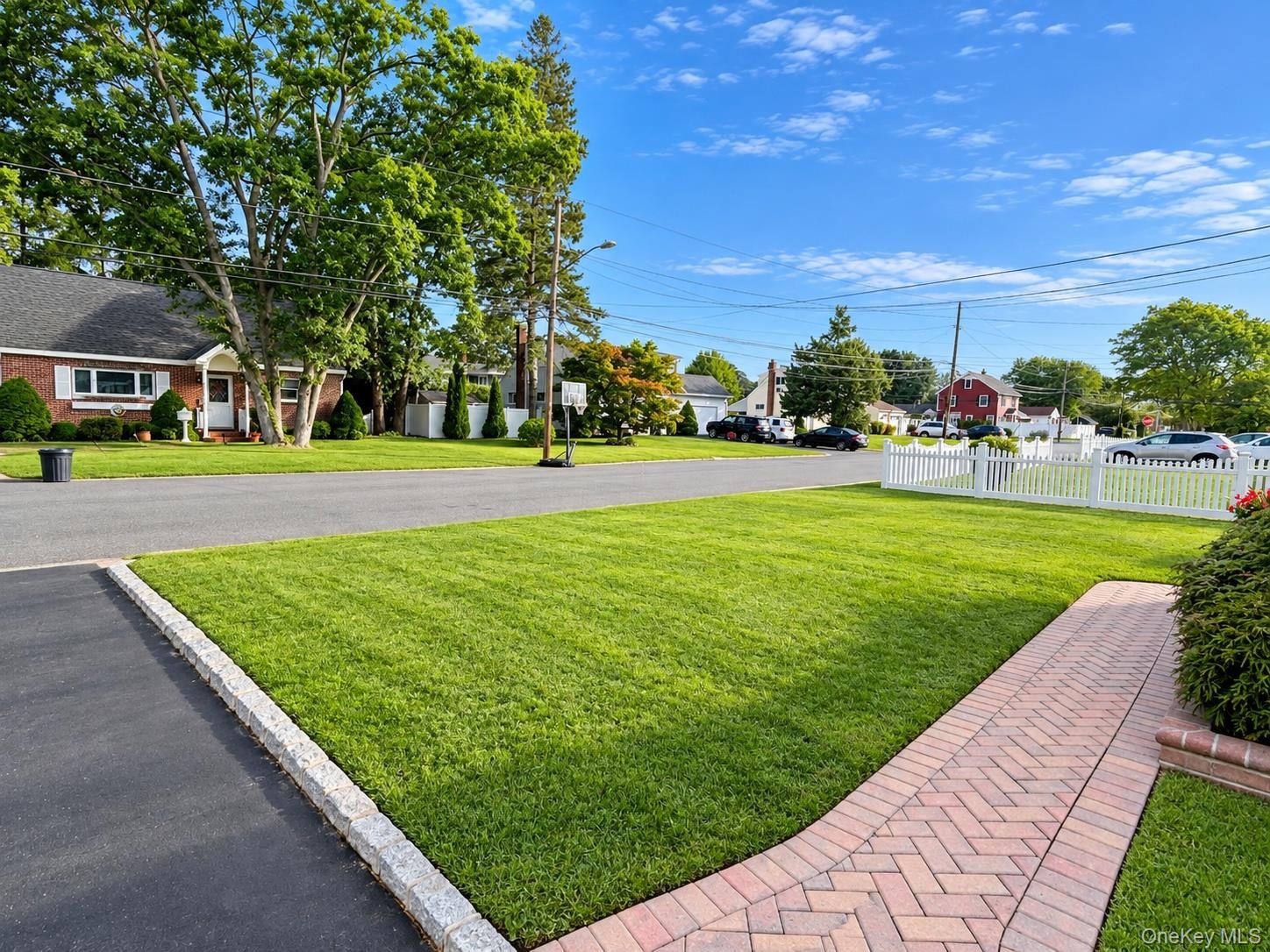 Wide & Quiet Street with "elbow" room. Brick paver sidewalk to front porch sitting area.