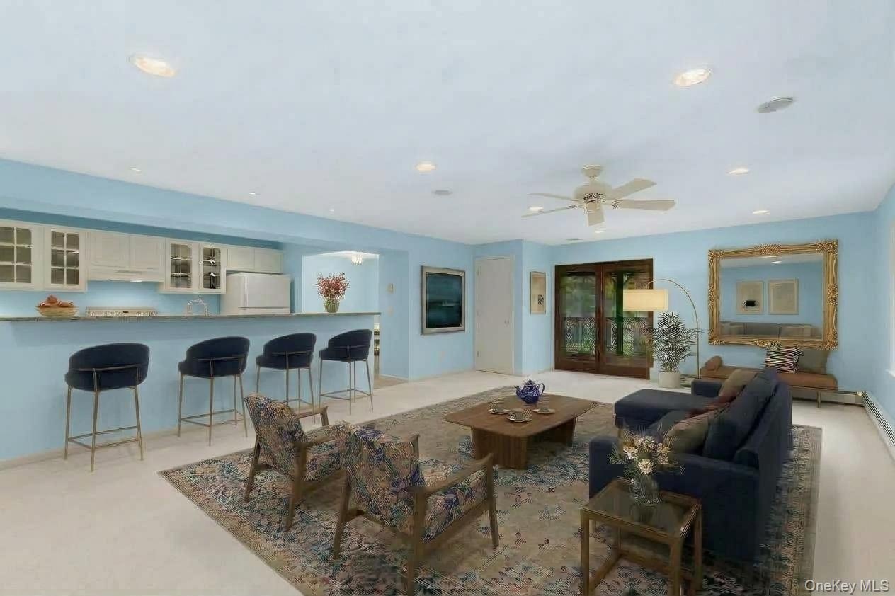 Virtually staged to showcase the lower-level living space as a warm and welcoming setting for gathering, entertaining, and relaxing.