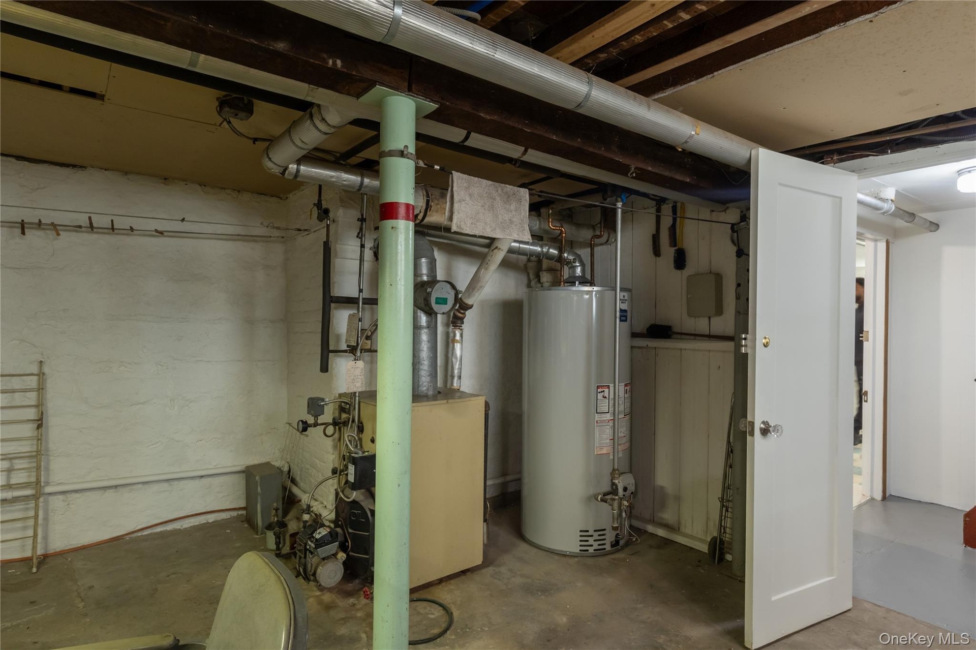 Utility room with water heater and boiler.