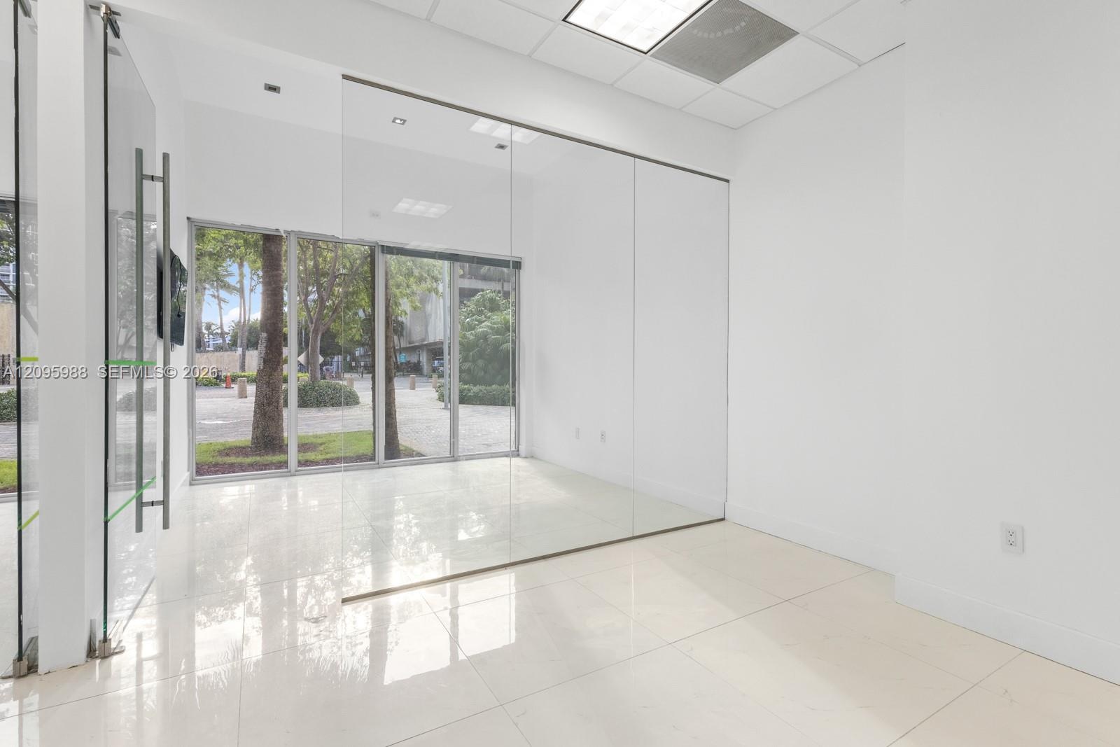 Glass-walled front room with storefront windows