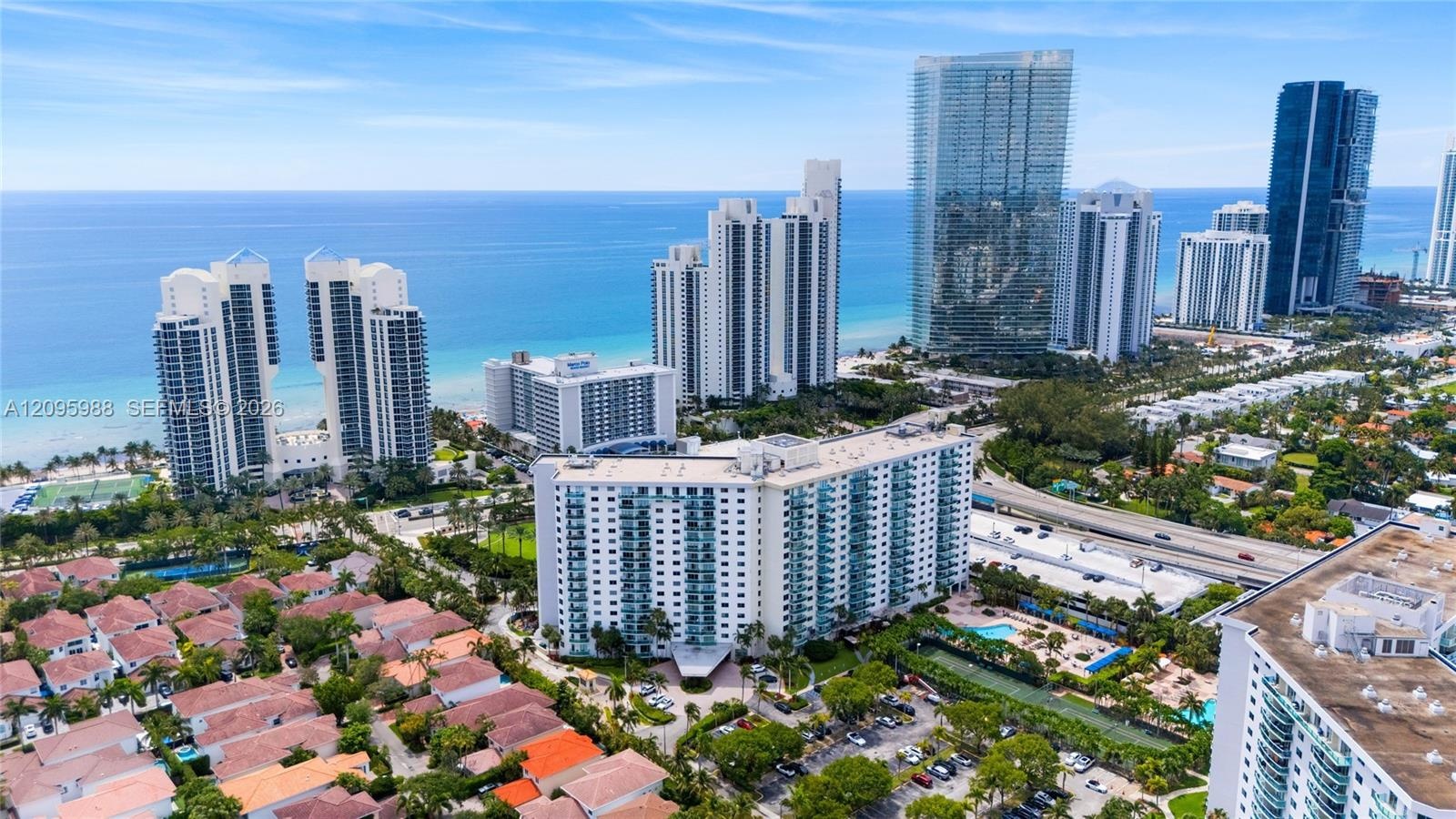 Ocean Reserve in its oceanfront neighborhood setting (aerial)