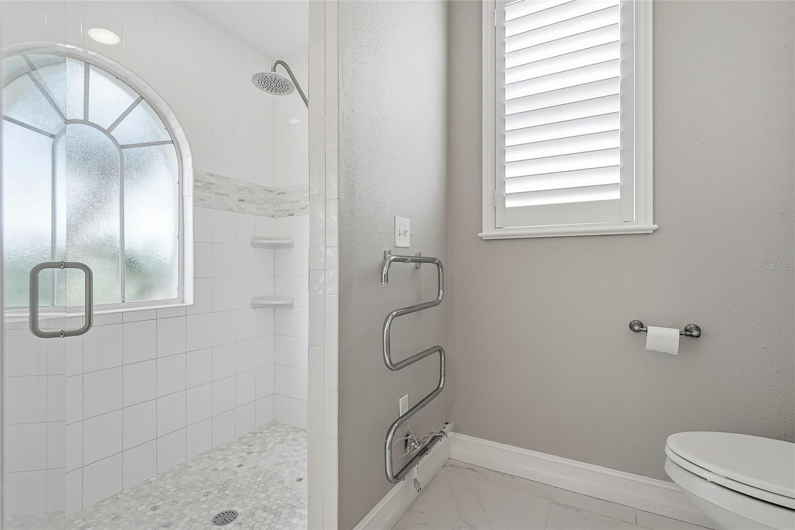 Luxurious shower and towel warmer.