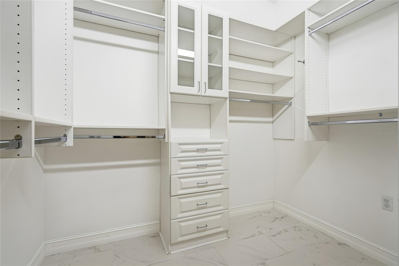 Wow! The primary walk-in closet is stunning with amazing custom shelving.