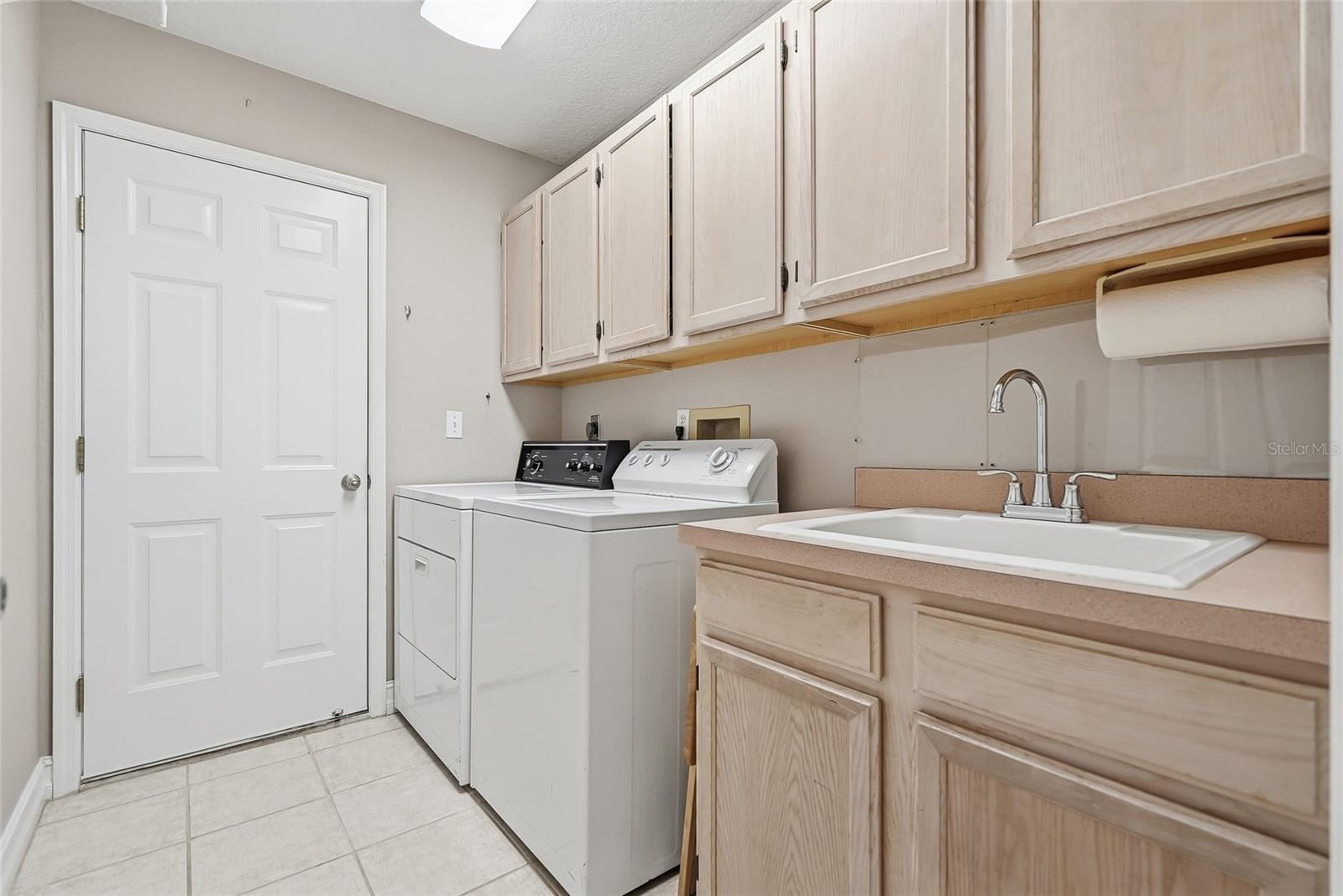 Interior laundry room with utility sink.