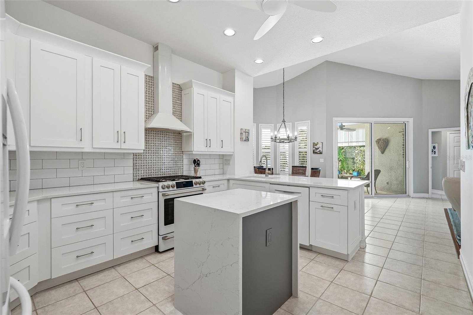 Absolute showstopper kitchen with electric-enhanced island, vented range hood, amazing cabinet and pantry space.