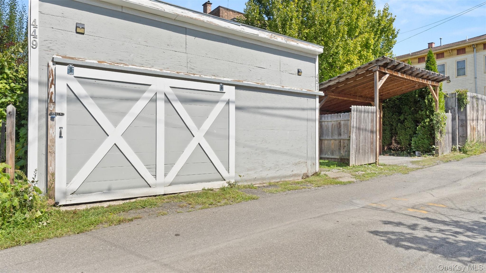 Off street parking with oversized garage with EV charger and a separate carport.