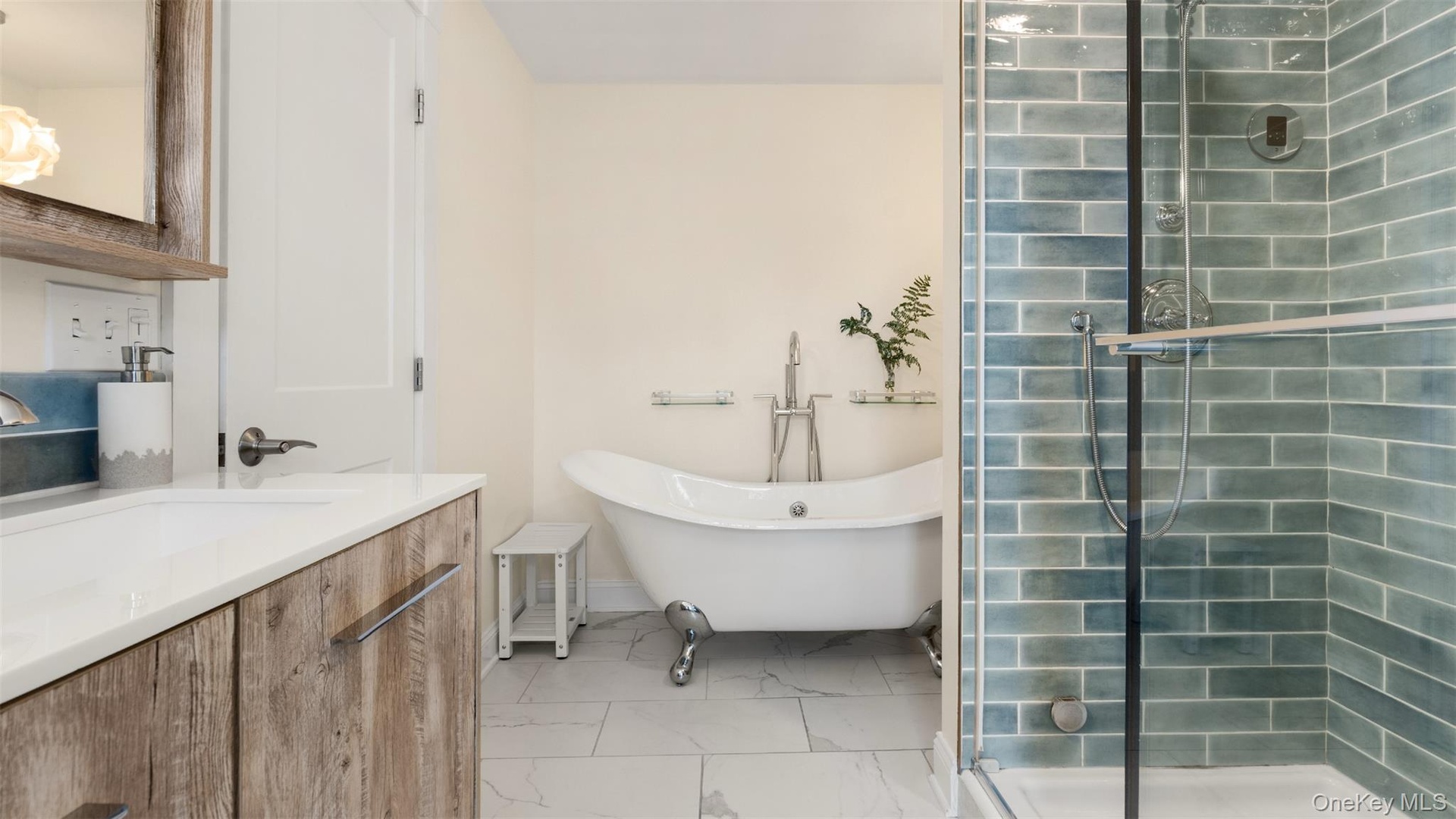 Primary ensuite bathroom with double vanity, tiled steam shower and soaking tub.