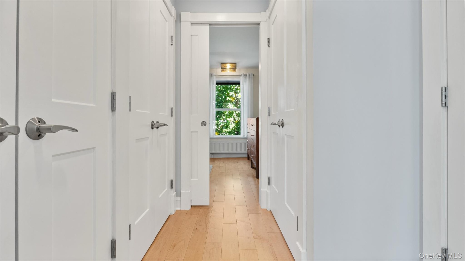 Hallway to third bedroom. Closets and laundry.