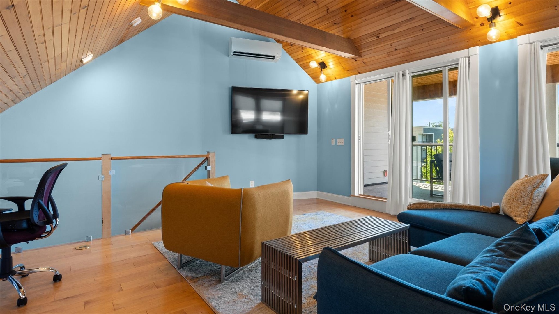 Vaulted ceiling, glass doors to third floor balcony.