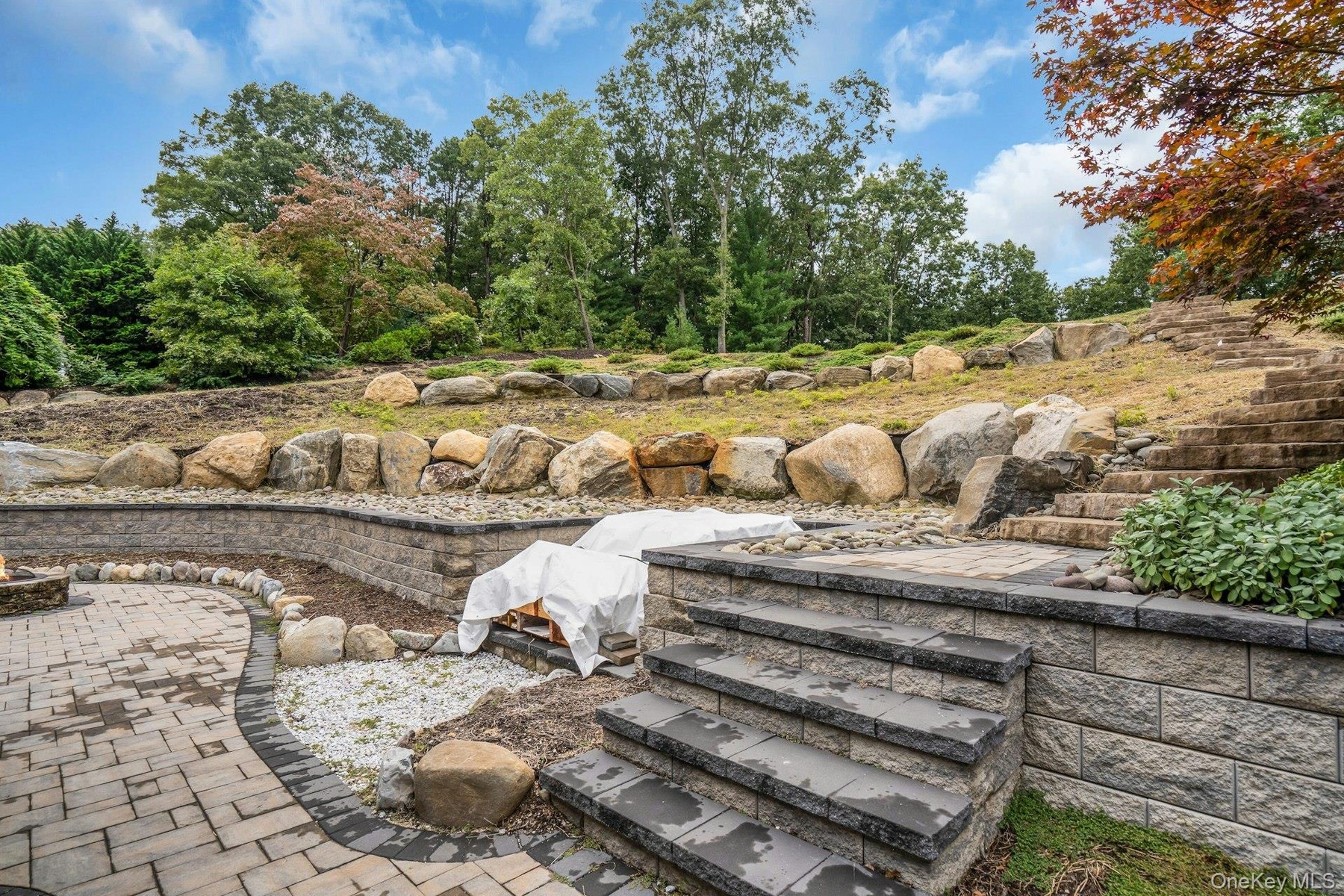 All new retaining walls and stone staircase with area for a hot tub.