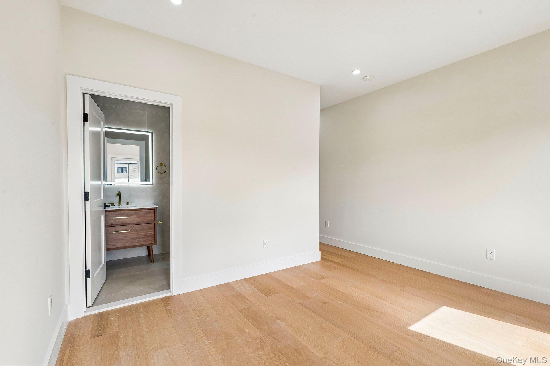Light wood-finish flooring with recessed lighting