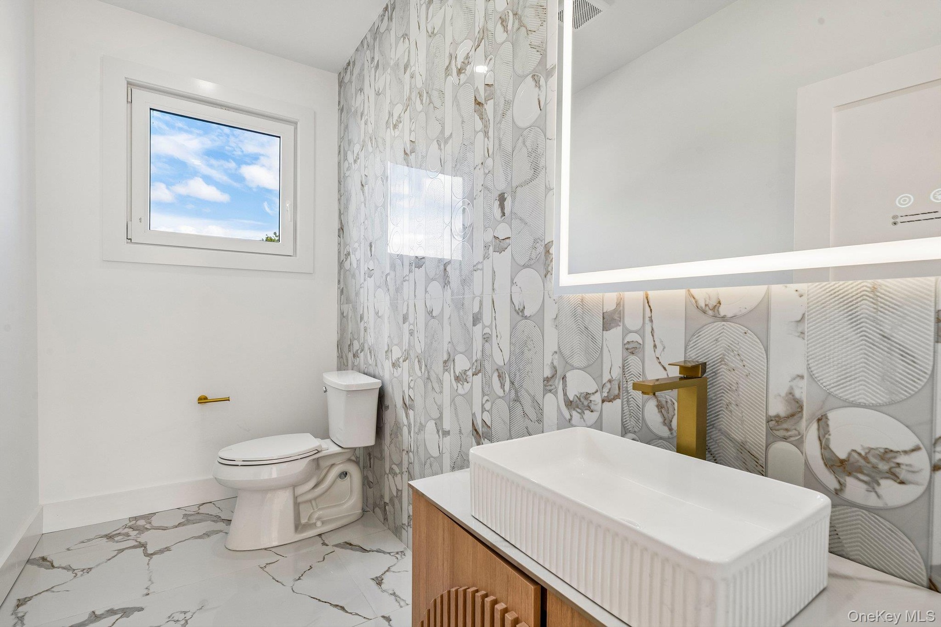 Modern vanity with an integrated rectangular vessel sink and brass-finish faucet