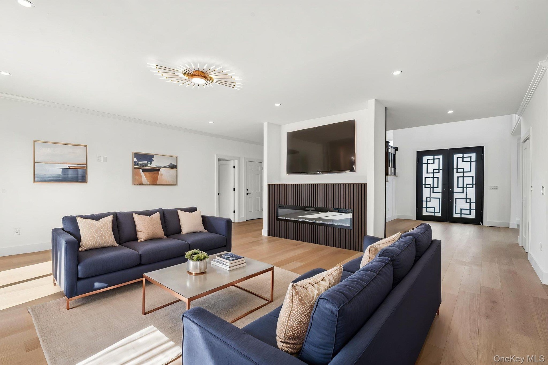Recessed lighting, wood-finish flooring, and a decorative ceiling fixture