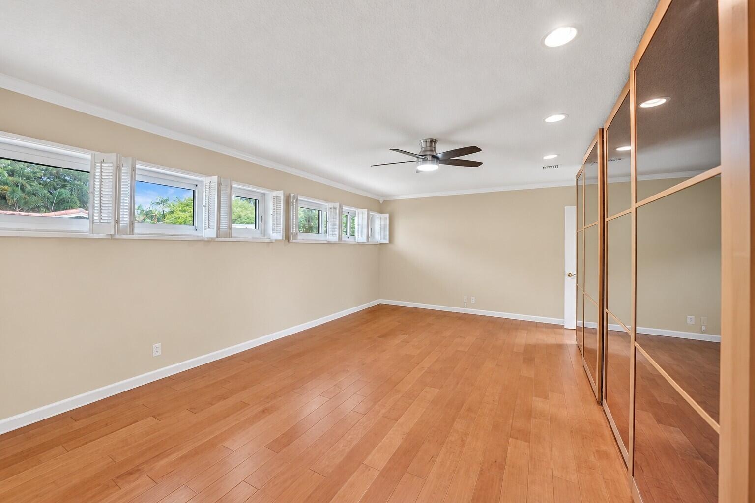 Wood-finish flooring, recessed lighting, and a ceiling fan