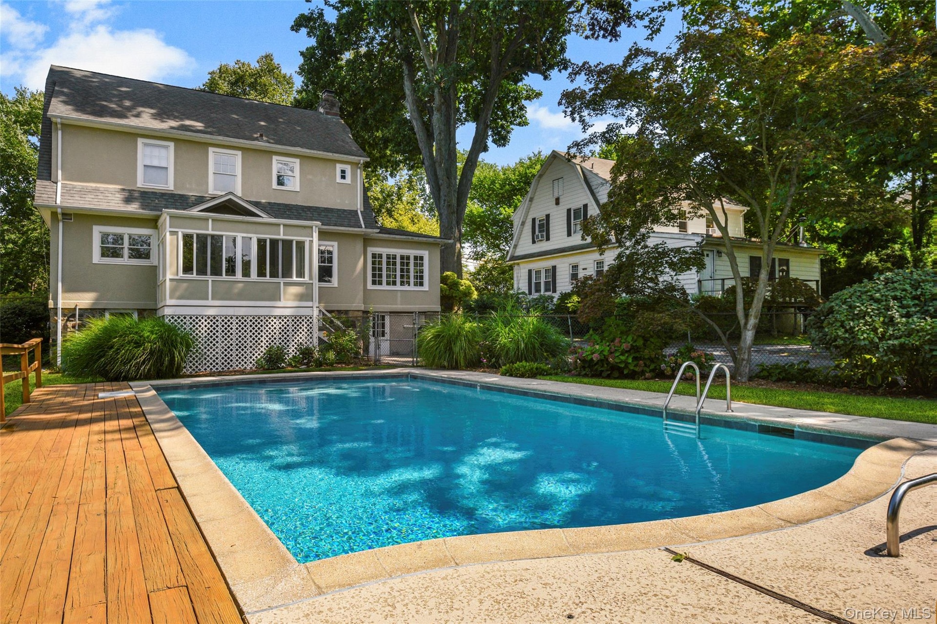 View over looking pool towards back of house.