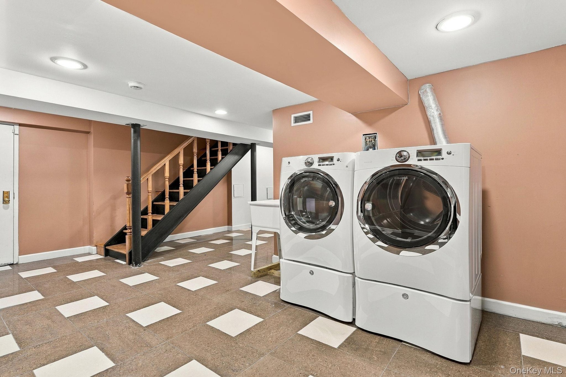 A beautifully finished lower level with dedicated laundry and ample utility space.