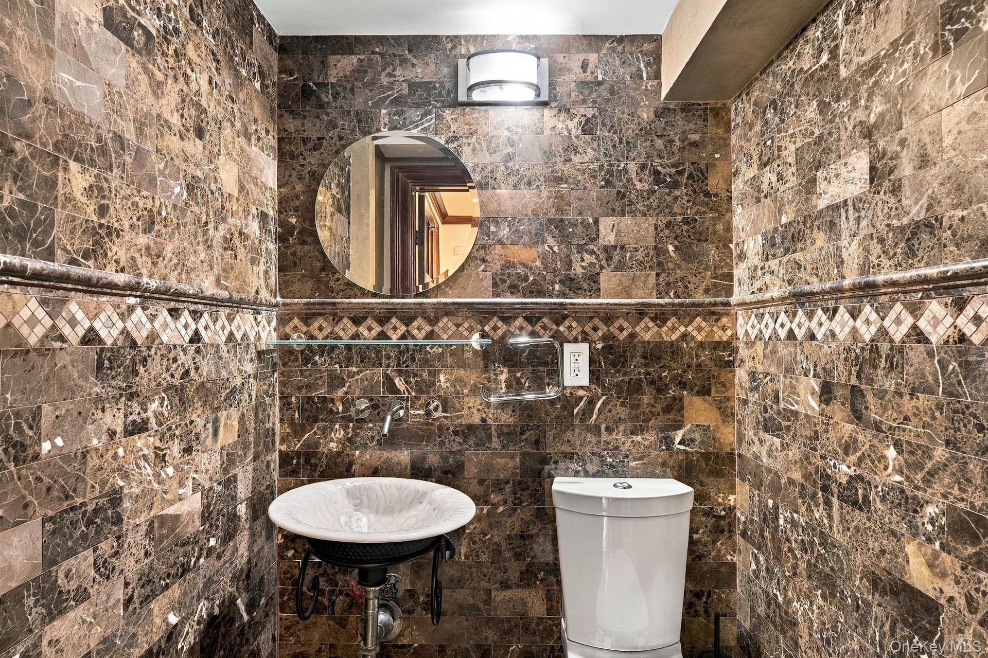 A marble-clad powder room adds a refined touch.