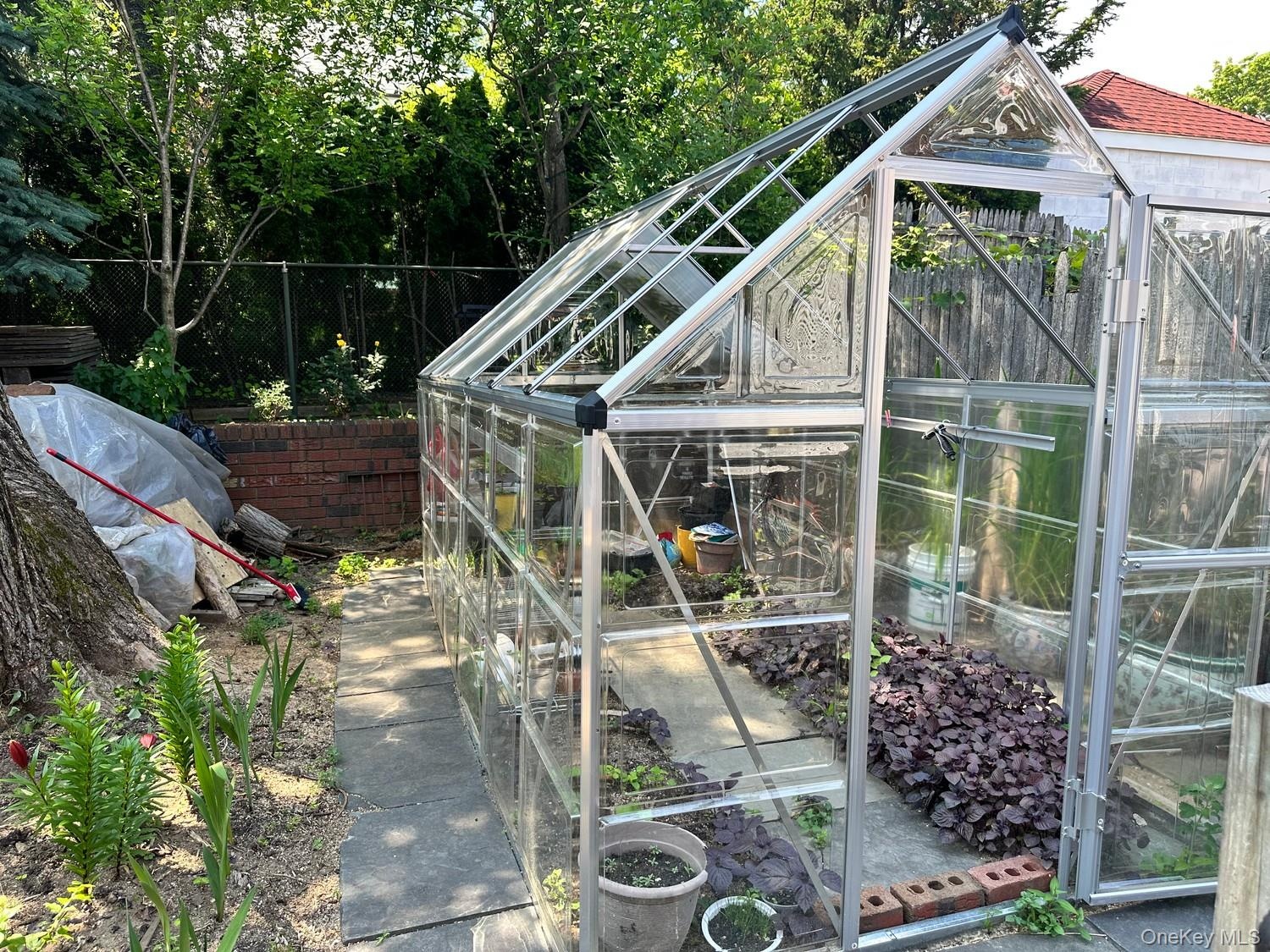 Charming Greenhouse nested in backyard, Perfect for gardening enthusiasts