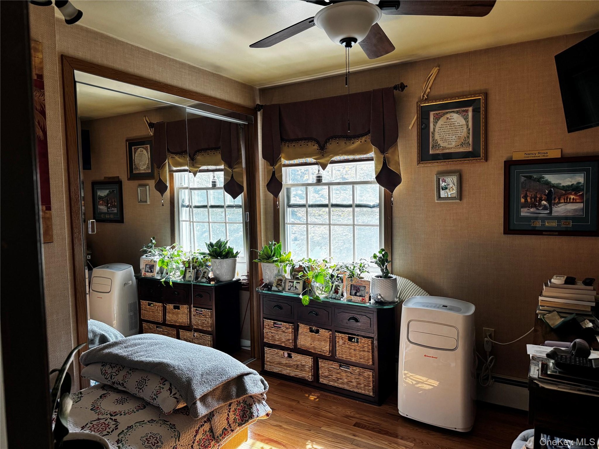Wood-finish flooring with a ceiling fan overhead