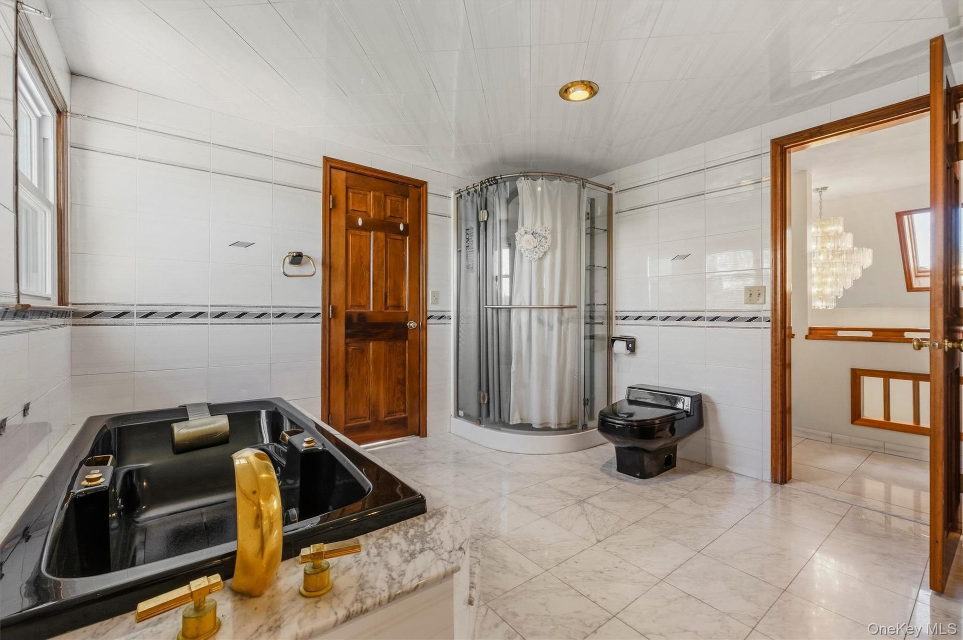 Bathroom with access to hall and second primary suite