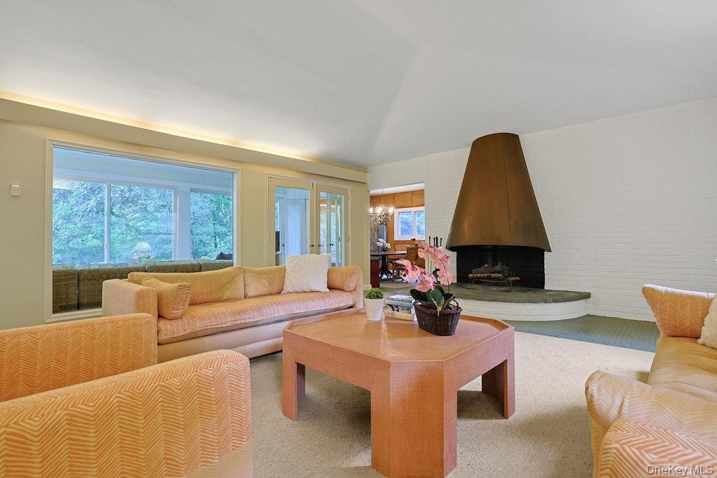 Spacious living room with oversized fireplace with copper hood