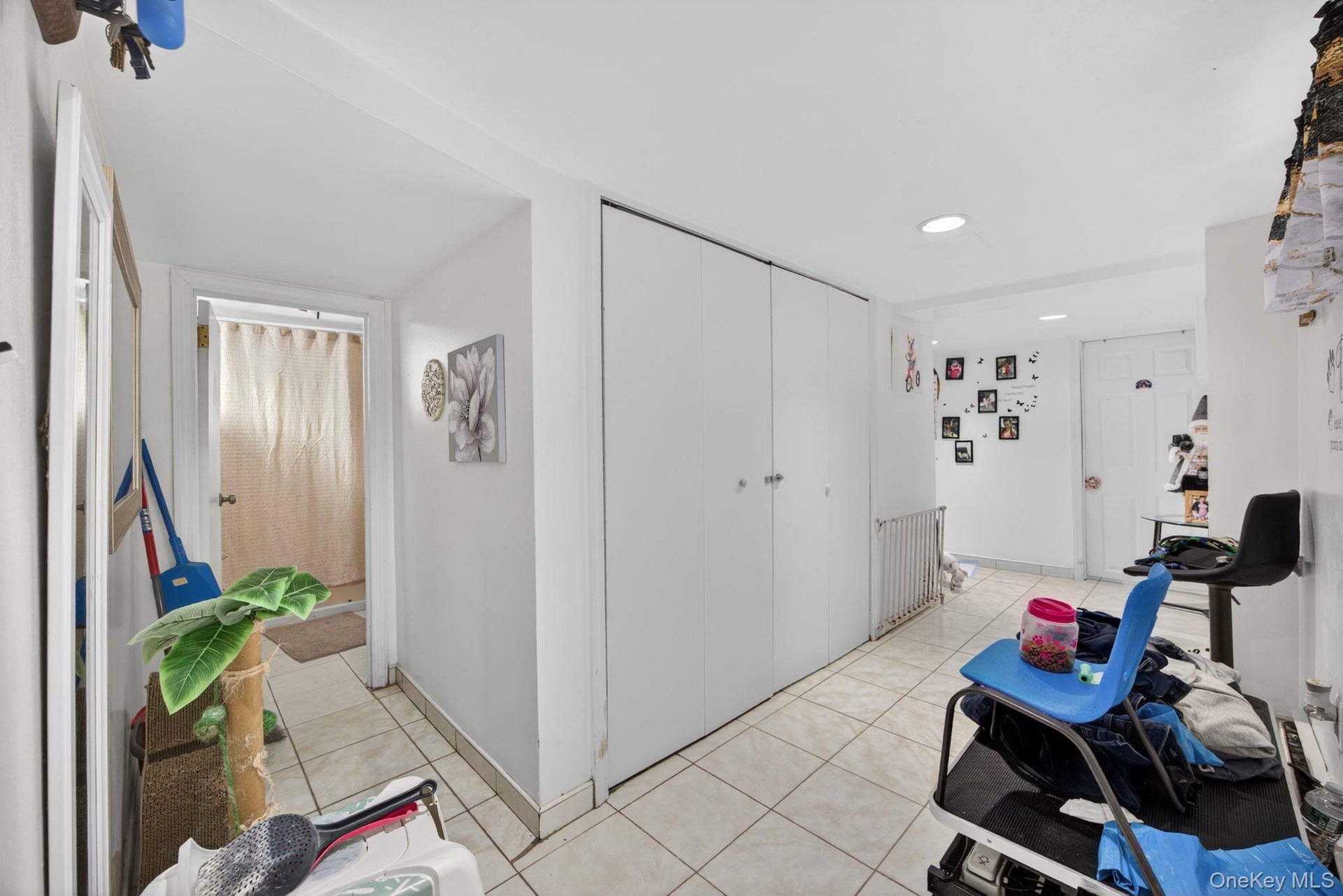 Corridor with light tile patterned floors and recessed lighting