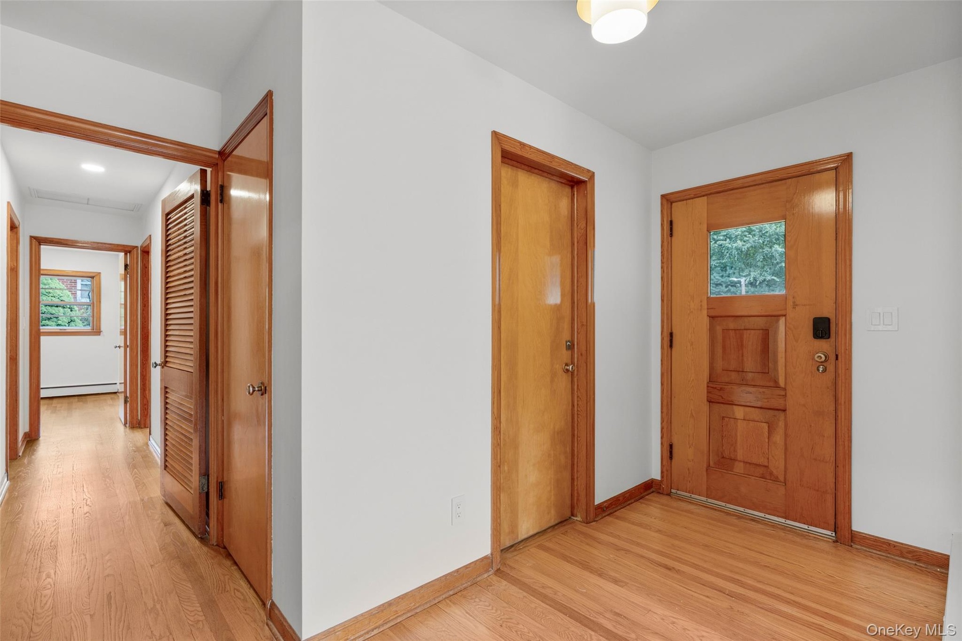 Entry foyer with pristine oak floors