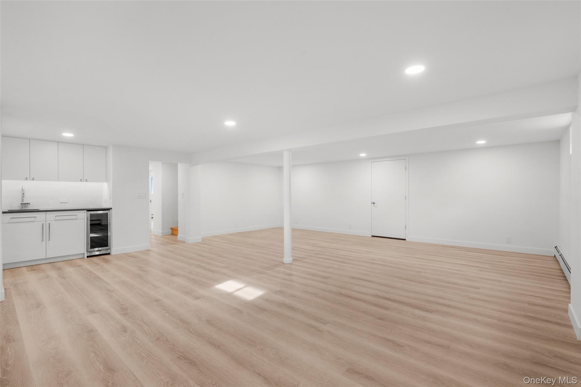 Finished basement with wet bar and engineered wood floors