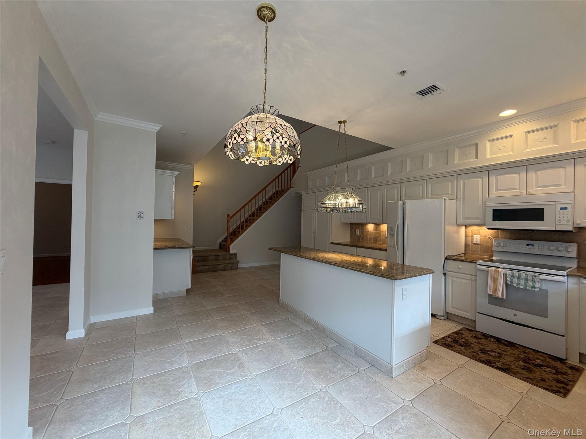 Custom finished cabinetry, added coffee bar, added pantry
