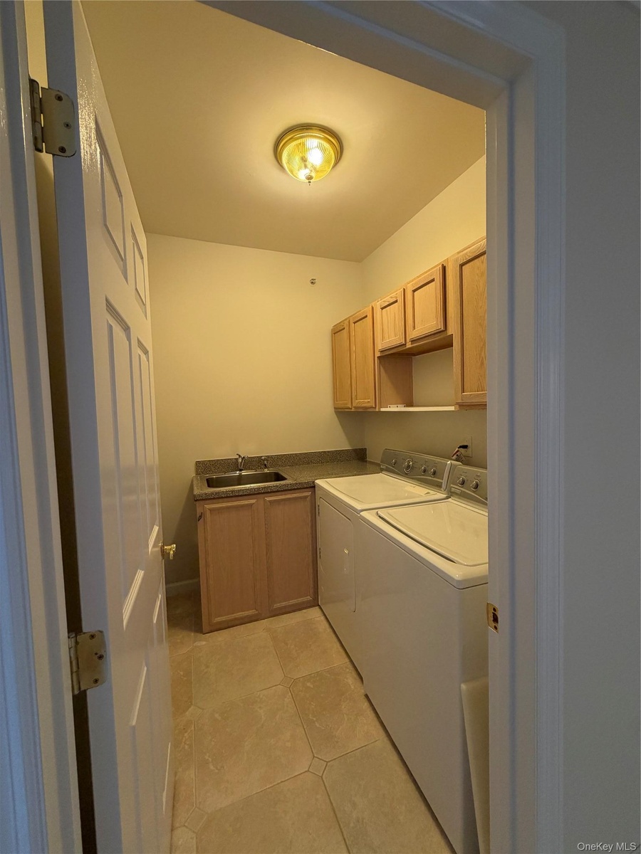 seperate laundry room, with sink, cabinetry and counters