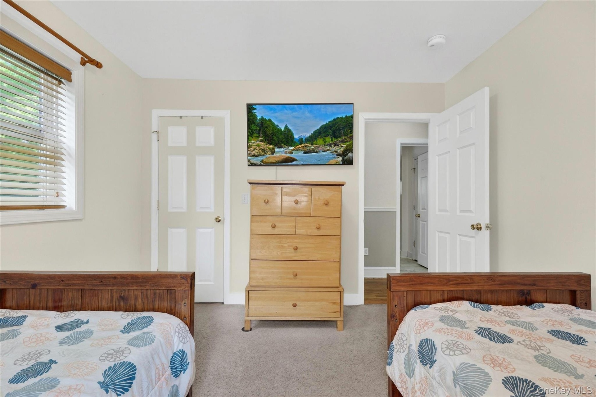 Neutral wall paint, built-in window with blinds, and white interior doors