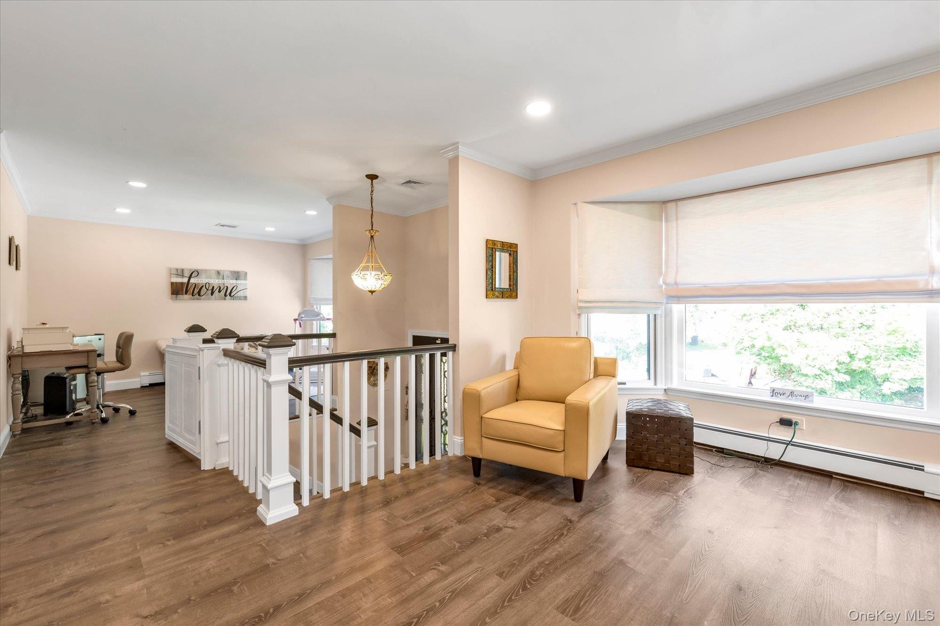 Sprawling living room area with large bay windows.