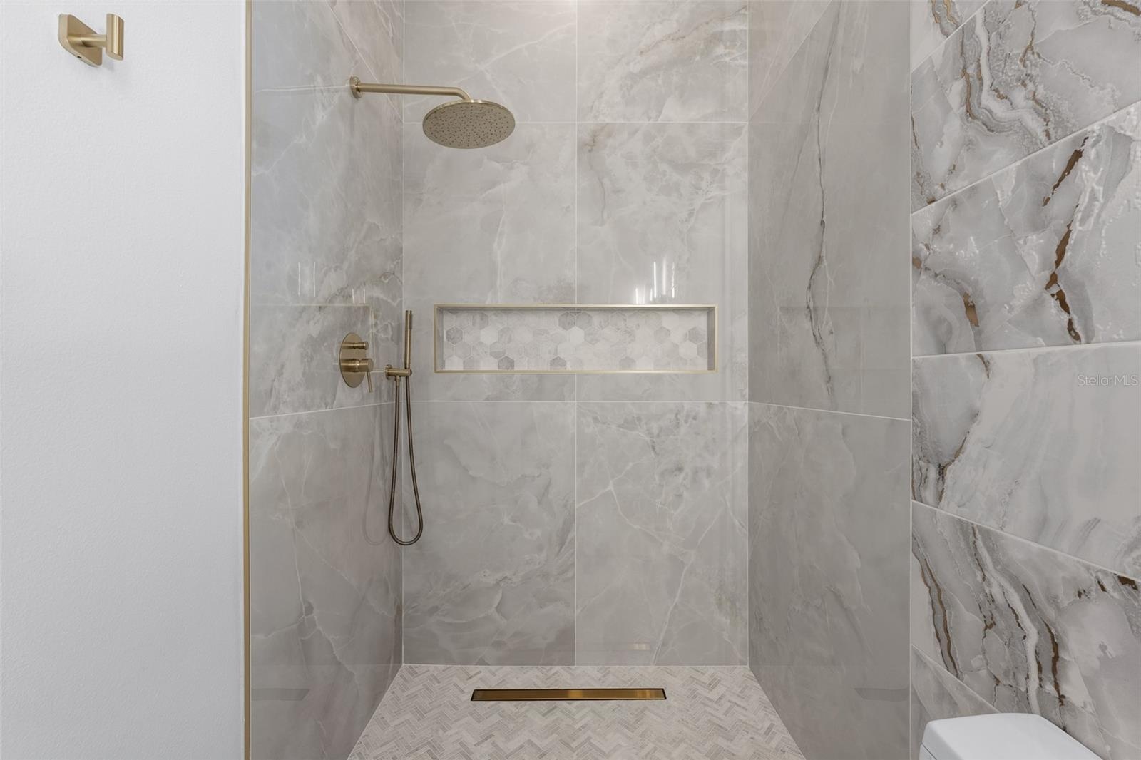 3rd Bathroom Walk-in shower with brass rain showerhead and wall niche.