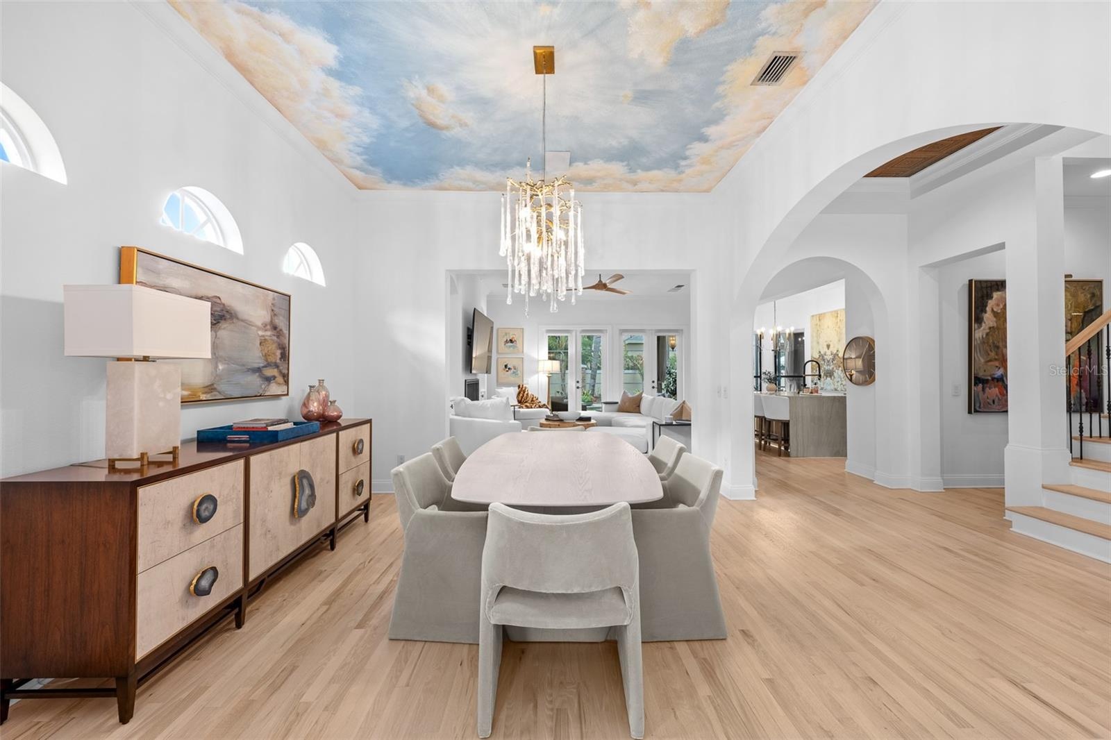 Dining area with arched windows and a sightline through to the kitchen and family room.