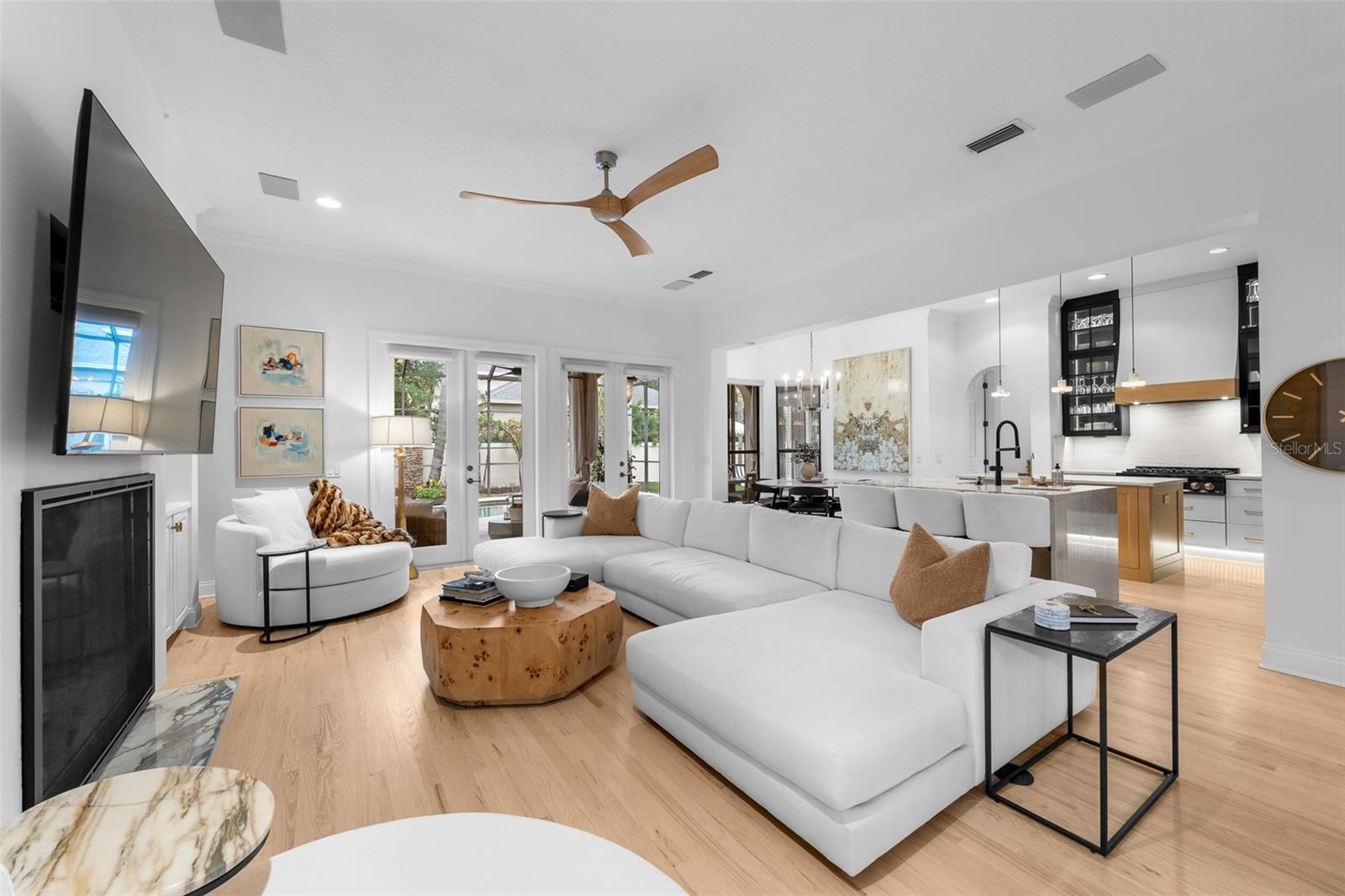 Open-concept family room with fireplace and view into the kitchen.