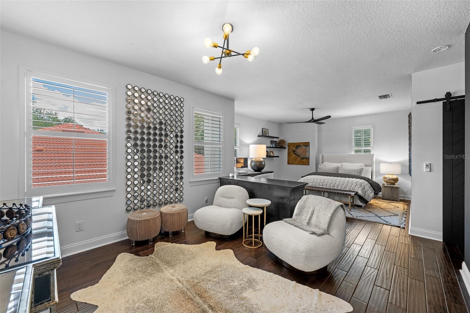 3rd Bedroom with sitting area — Bedroom with separate seating area, barn door, and modern light fixture.