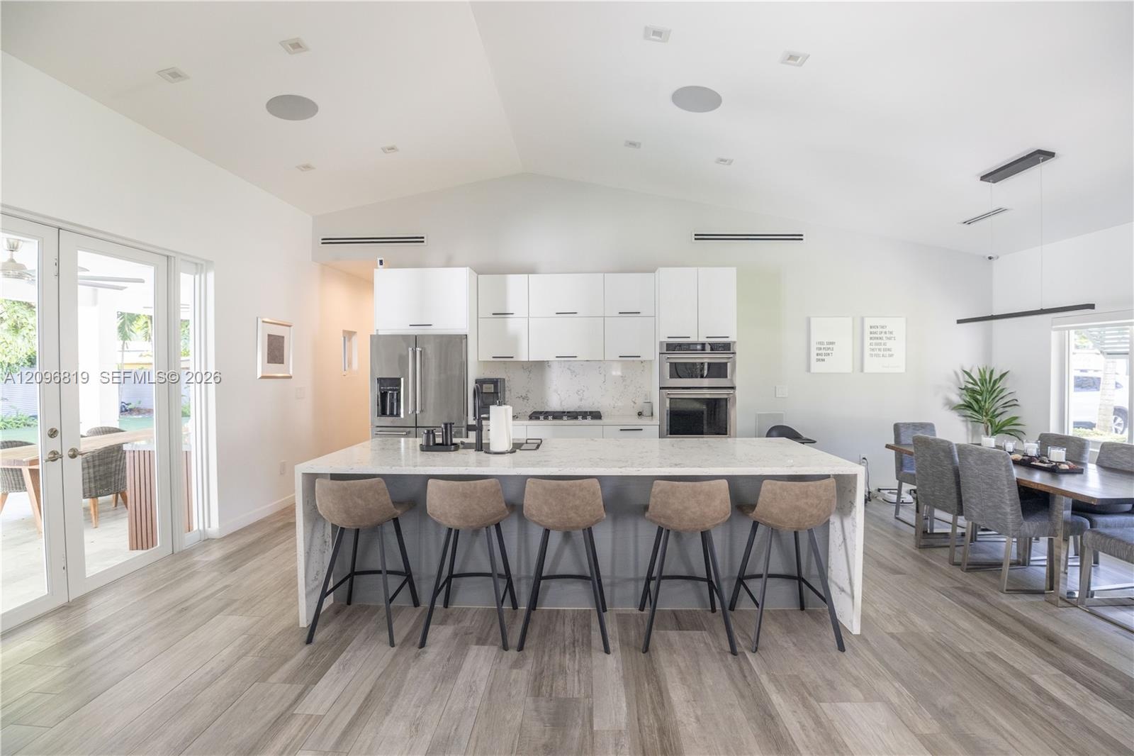 Oversized Kitchen island with generous counter space and ample seating, perfect for entertainment.