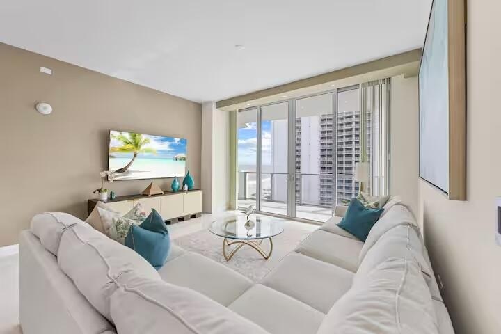 Expansive living area with neutral wall tones and recessed lighting