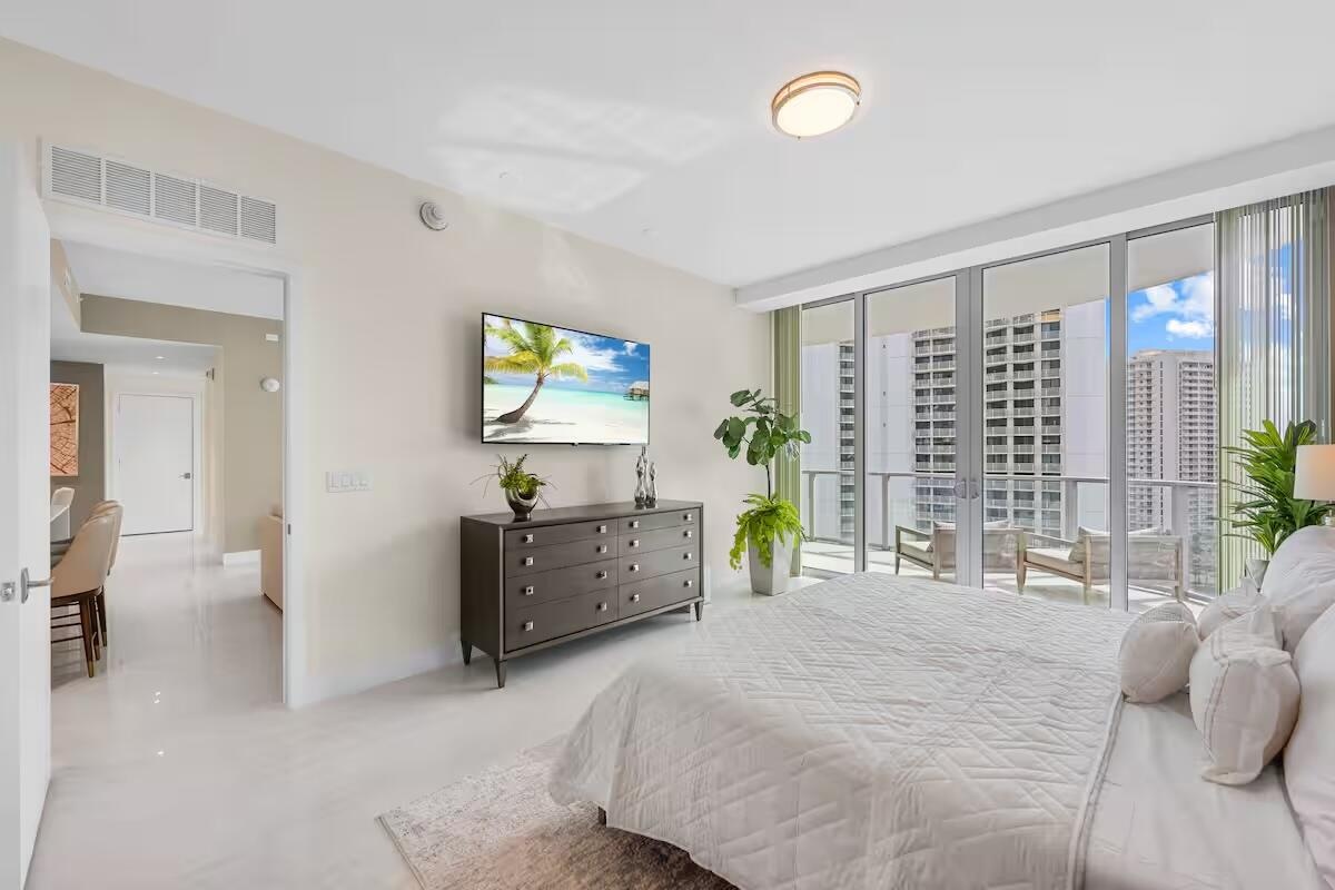 Floor-to-ceiling glass doors opening to a private balcony