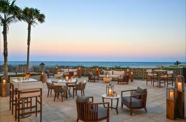 Expansive outdoor terrace featuring a hardscaping surface and a decorative perimeter wall