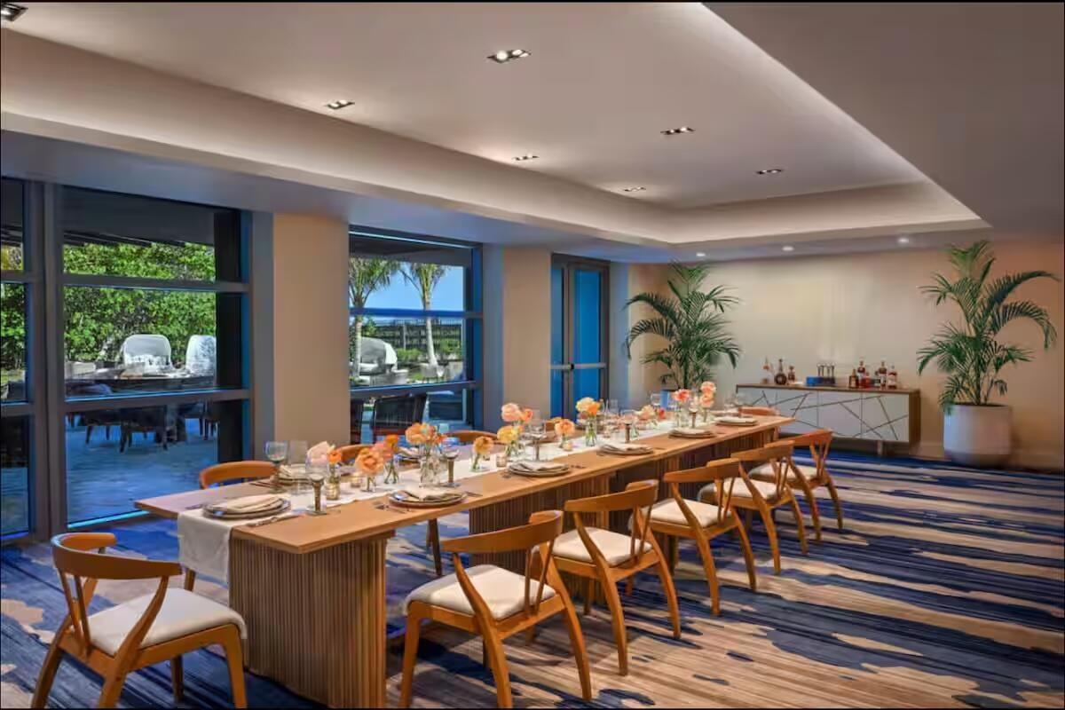 Recessed lighting, tray ceiling, full-height glass panels, accent wall with built-in cabinetry, and patterned carpet flooring