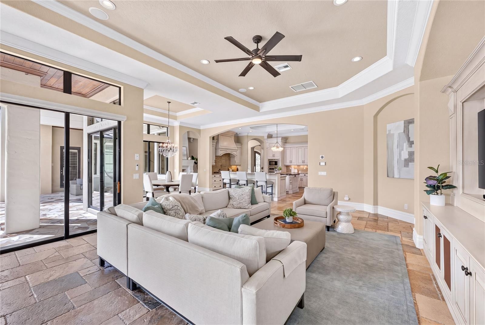 Casual family room with built-in TV wall (all televisions CONVEY with the house). Notice the speakers in the ceiling. The WHOLE house has a newly adde