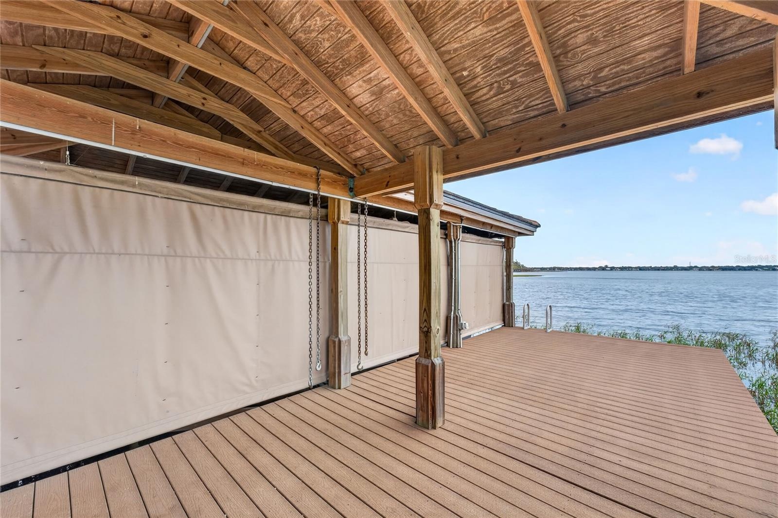 The 30'x12' Boat House can hold up to a 29' boat and has an NEW electric LIFT for up to 5500 lbs. and NEW remote cover. Underneath a Regal LS4 Fully L