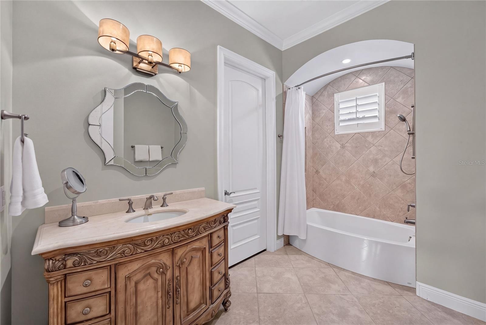 Ensuite Bath for Bedroom 7. The door shown leads to custom closet, SECONDARY UPSTAIRS LAUNDRY and another door to smaller mechanical area and attic ac