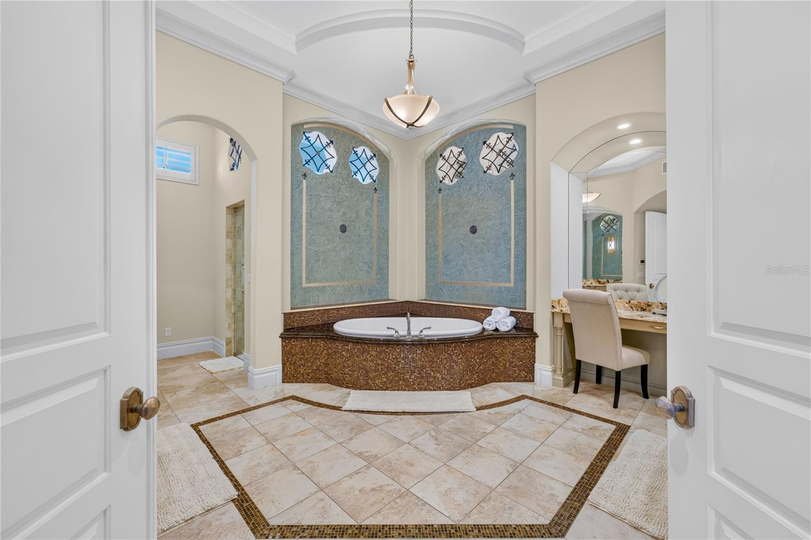 This primary bath was remodeled in 2020 and features soaking jetted spa tub, his & her granite topped vanities, make-up area, STEAM multi-head shower 