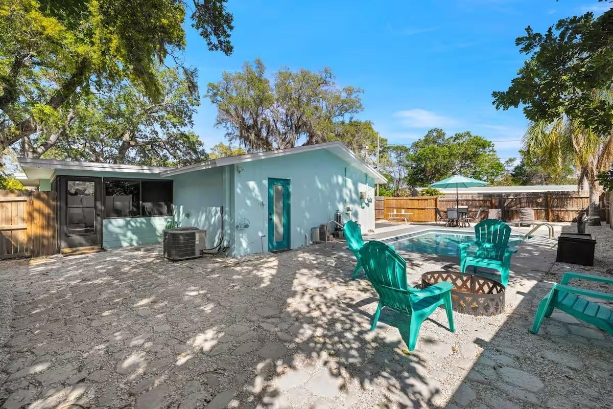 A fully fenced backyard offers more than just a pool, with a dedicated fire-pit area and plenty of space to gather outdoors.