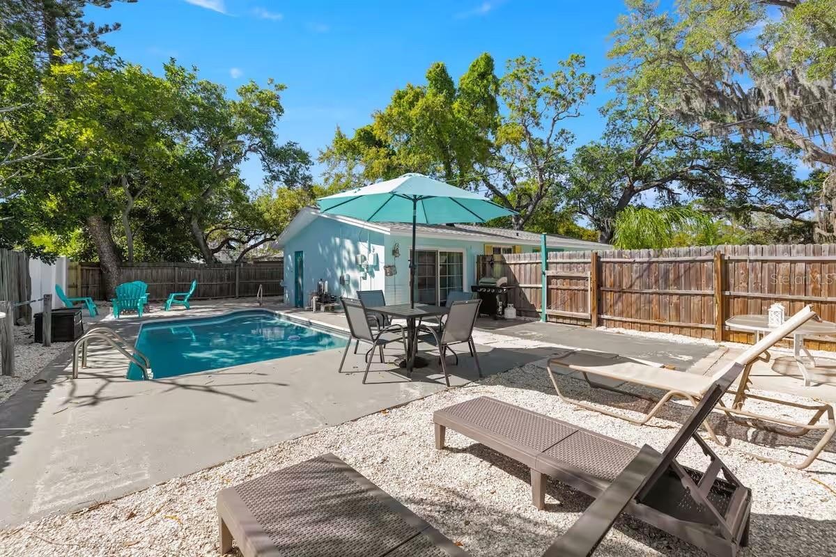Plenty of room to spread out around the pool, with dedicated areas for dining, grilling, lounging, and enjoying the Florida sunshine.